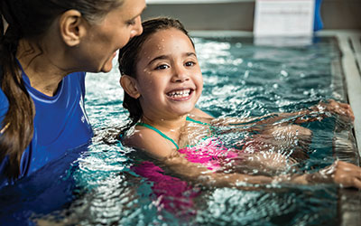 A young girl learning how to swim